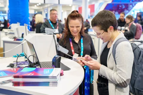 Two people at a conference kiosk.