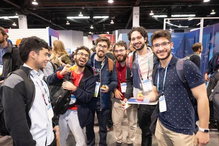 A group of conference attendees smiling for a photo.