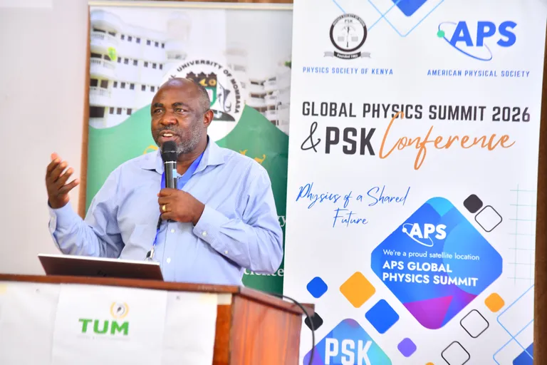 A meeting attendee speaks at a satellite site in Kenya.