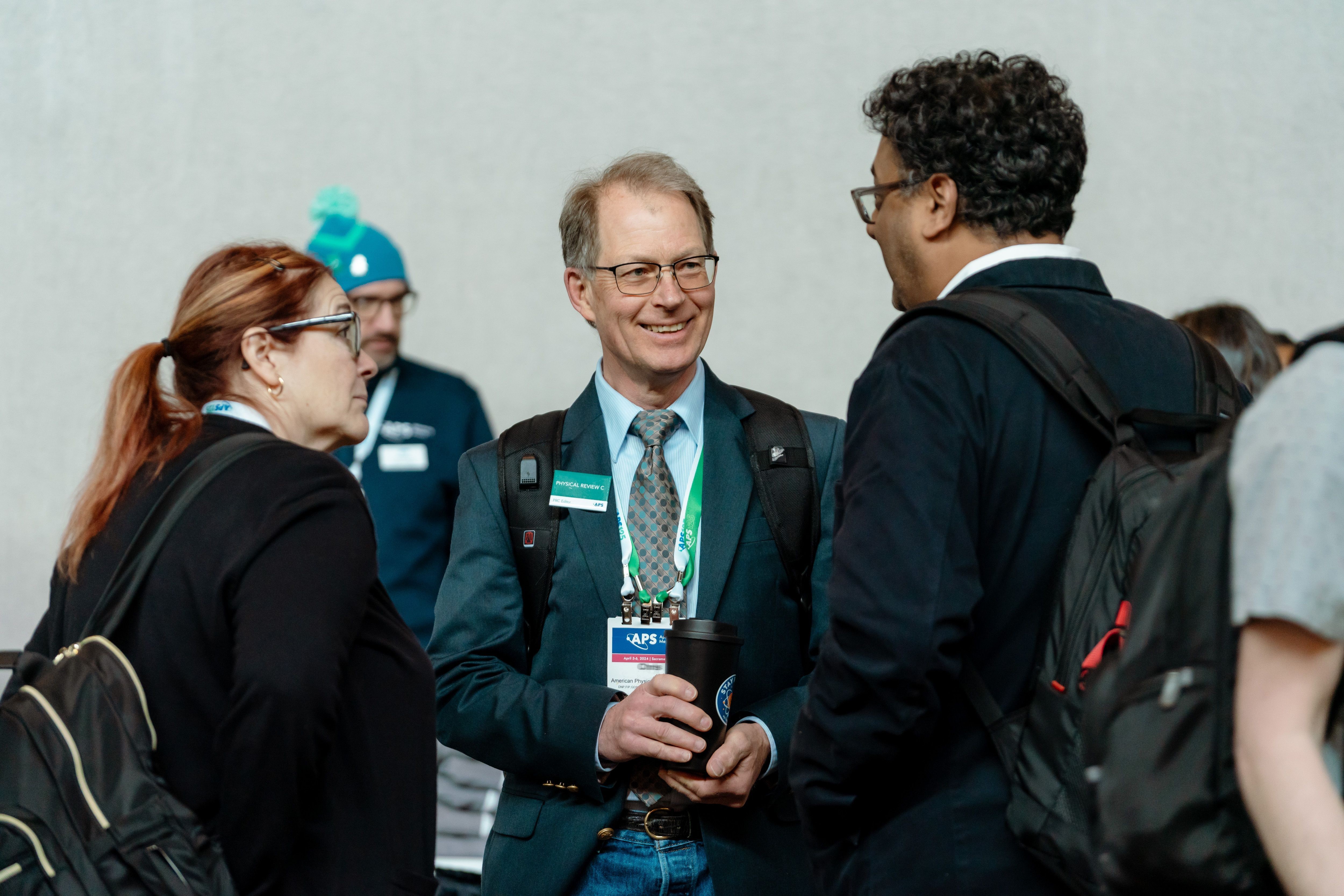 Attendees talking in between scientific sessions.